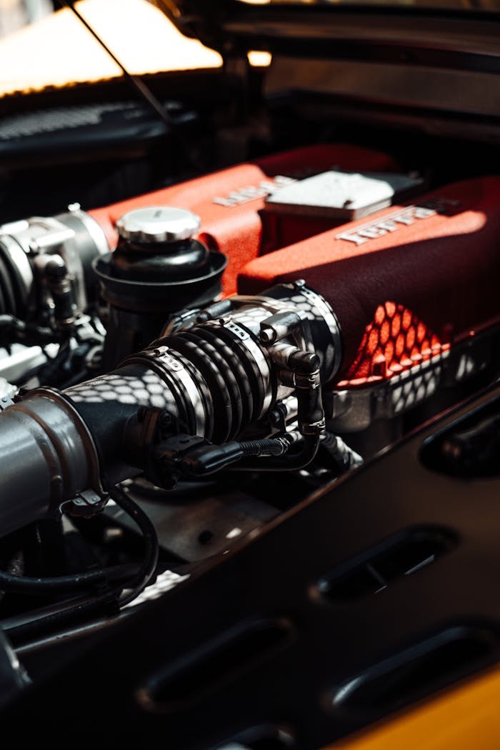 Detailed view of a high-performance car engine, showcasing power and engineering under sunlight.